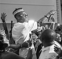 Ghanaian highlife musician KK Fosu holding microphone on stage