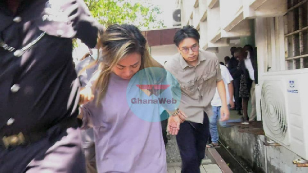 Aisha Huang and one of her co-accused after a court appearance