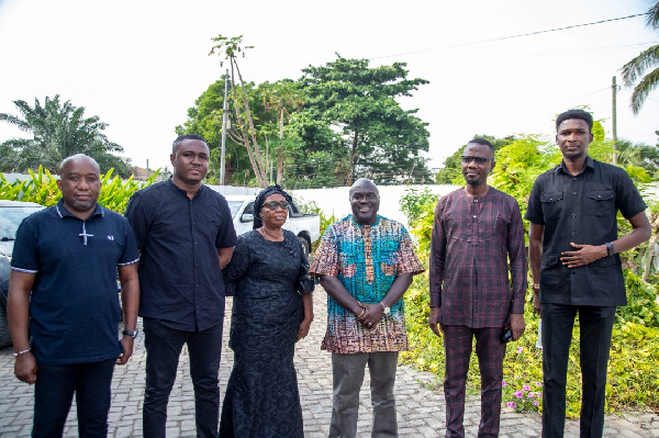 The family in a group photo with Julius Debrah