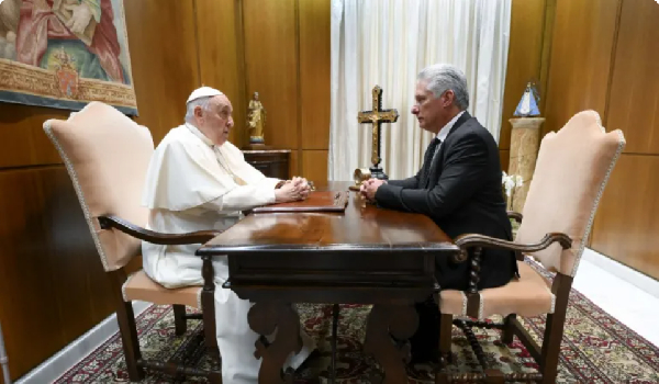 Pope Francis speaks with Cuban President Miguel Diaz-Canel before a meeting at the Vatican