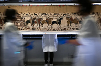 Workers and volunteers prepare to pack the Bayeux Tapestry to transfer to the British Museum
