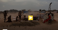Gold panners break stones in Kidal, Mali, on January 23, 2020