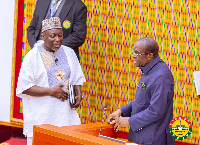 Mohammed Baba Jamal Ahmed (l) during his swearing in ceremony