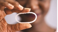 A woman holds a diaphragm of a vaginal contraceptive ring