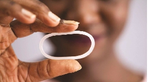 A woman holds a diaphragm of a vaginal contraceptive ring