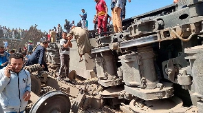 People gather around a wreckage south of the Egyptian capital Cairo