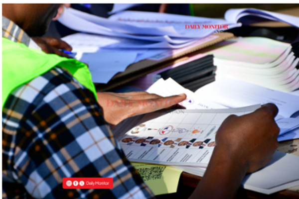 An Electoral Commission official prepares voting materials as voting got underway in Kampala