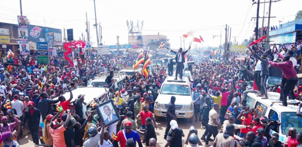 Robert Kyagulanyi gestures to supporters on his way to campaign in Nakaseke District