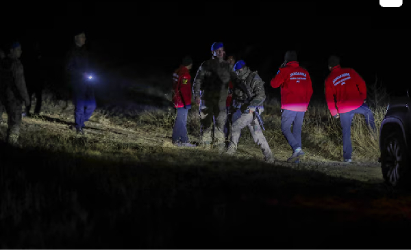 Turkish security forces and search and rescue teams work around the crash site