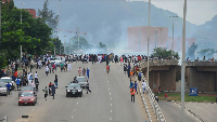 Police fire tear gas during a protest against Nigeria's cost-of-living crisis in Abuja on Aug. 1, 20