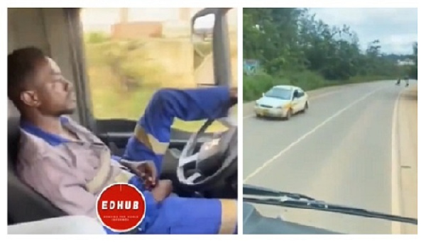 The truck driver steering with his legs