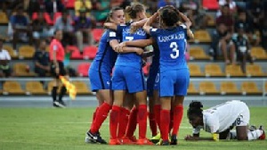 France celebrate while a Ghanaian player goes down on her knees in disappointment