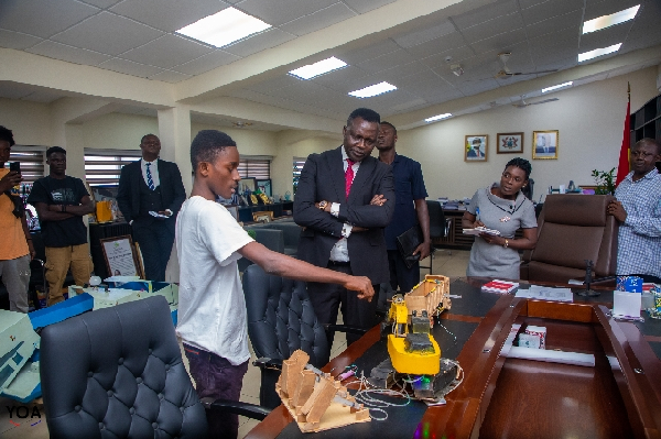 The innovator demonstrating how his invention works to the Minister