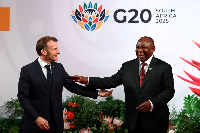 French President Emmanuel Macron is greeted by South Africa's President Cyril Ramaphosa