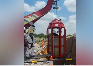 A cage being lowered down from the top of the disused shaft to bring the miners back to the surface